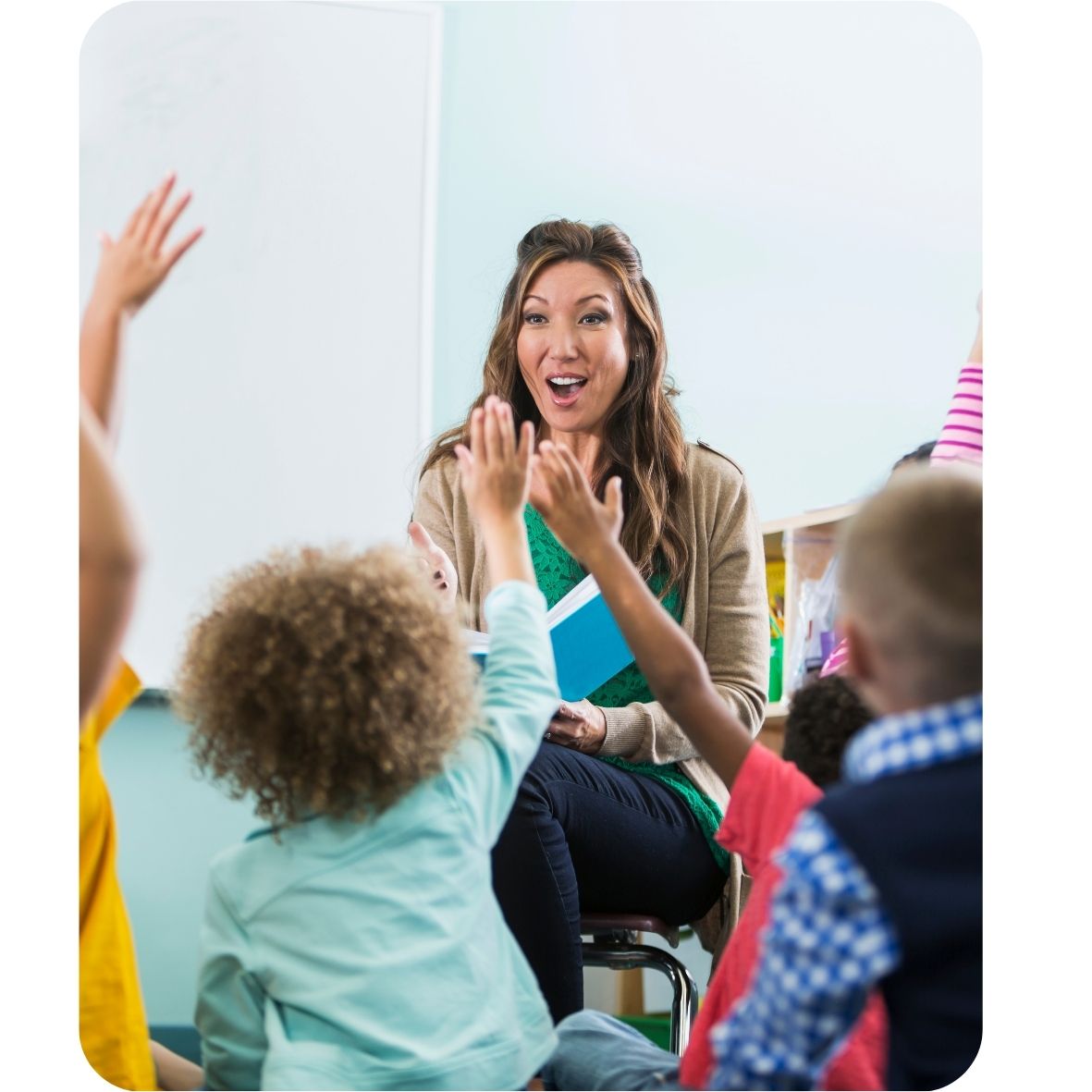 Teacher interacting with children in a classroom setting