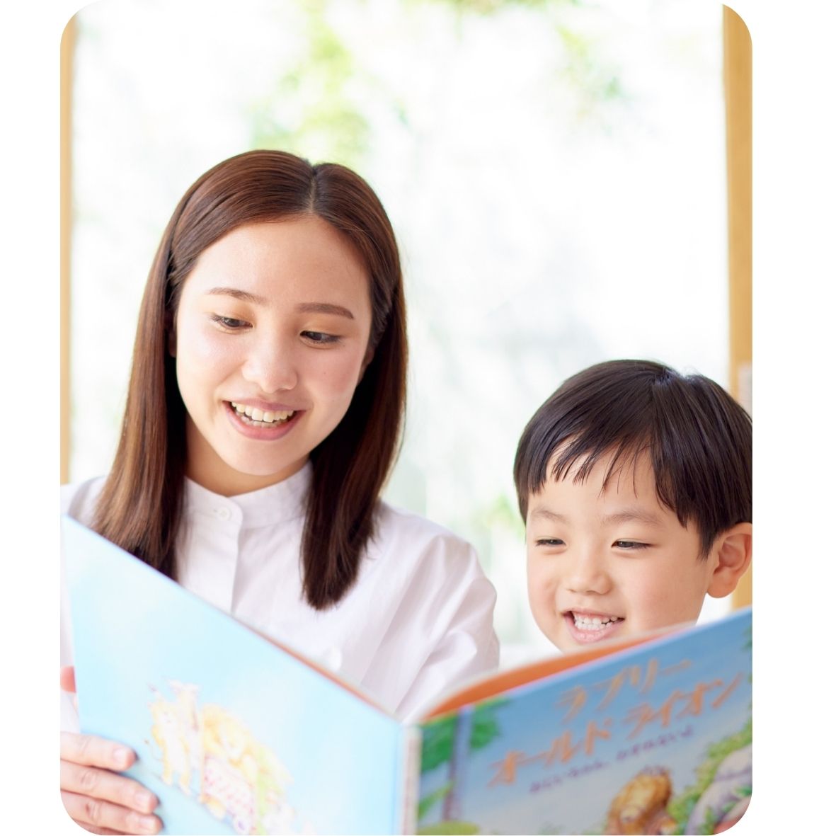 Woman and child reading a book together with a blurred background