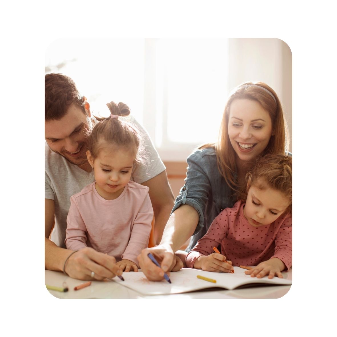 Family of four, two adults and two children, engaged in an activity together.