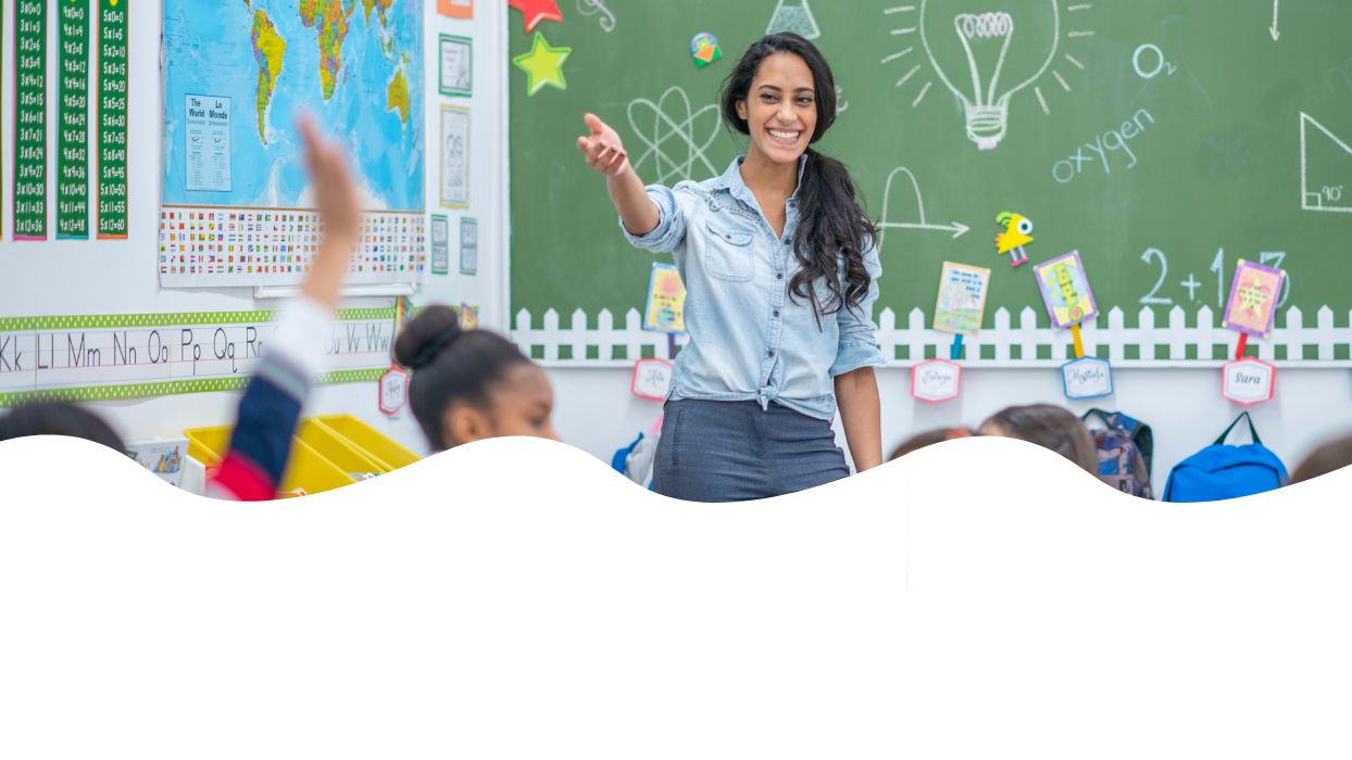 primary school teacher happy to teach creative writing in an engaged classroom